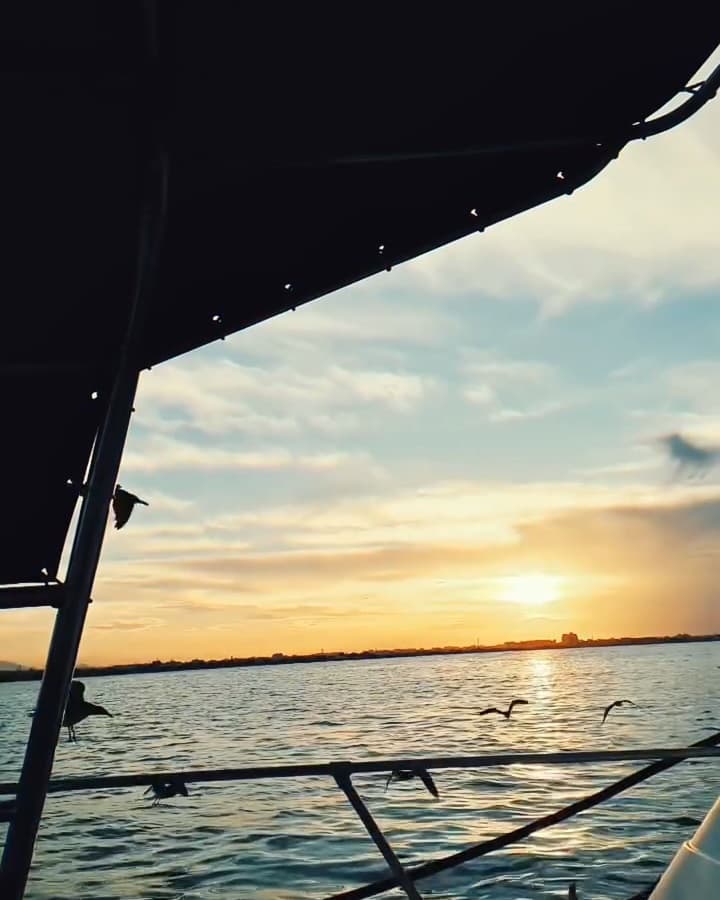 Sunset over the sea seen from a Horizon Blue boat off Muscat